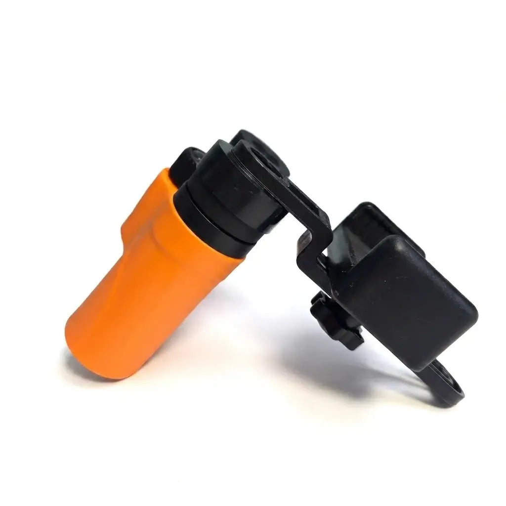 Side view of the orange Apresys Luck Mini binoculars with the universal smartphone adapter attached for mobile photography.