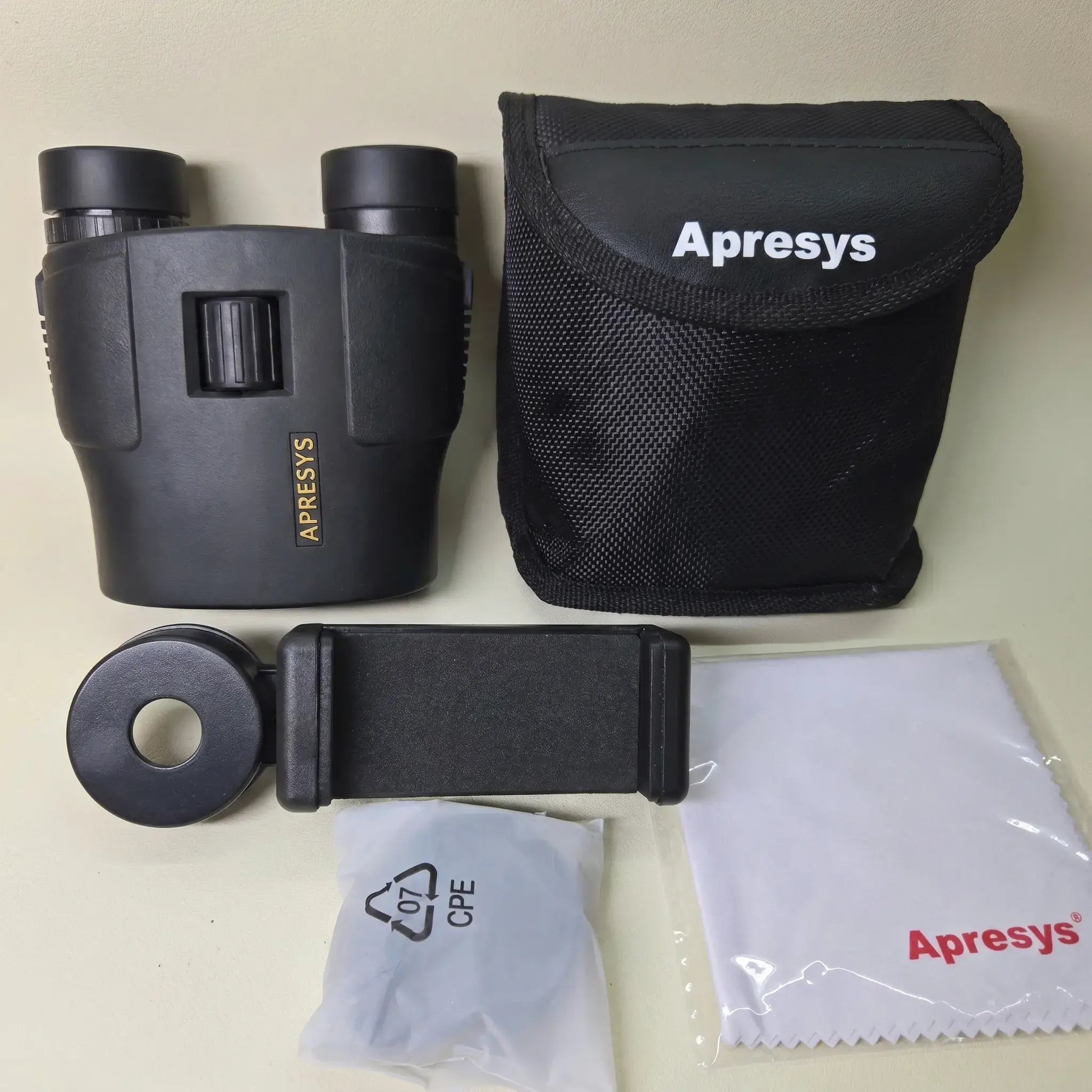 APRESYS M0825 full set including binoculars, carrying case, phone adapter, cleaning cloth, and neck strap.