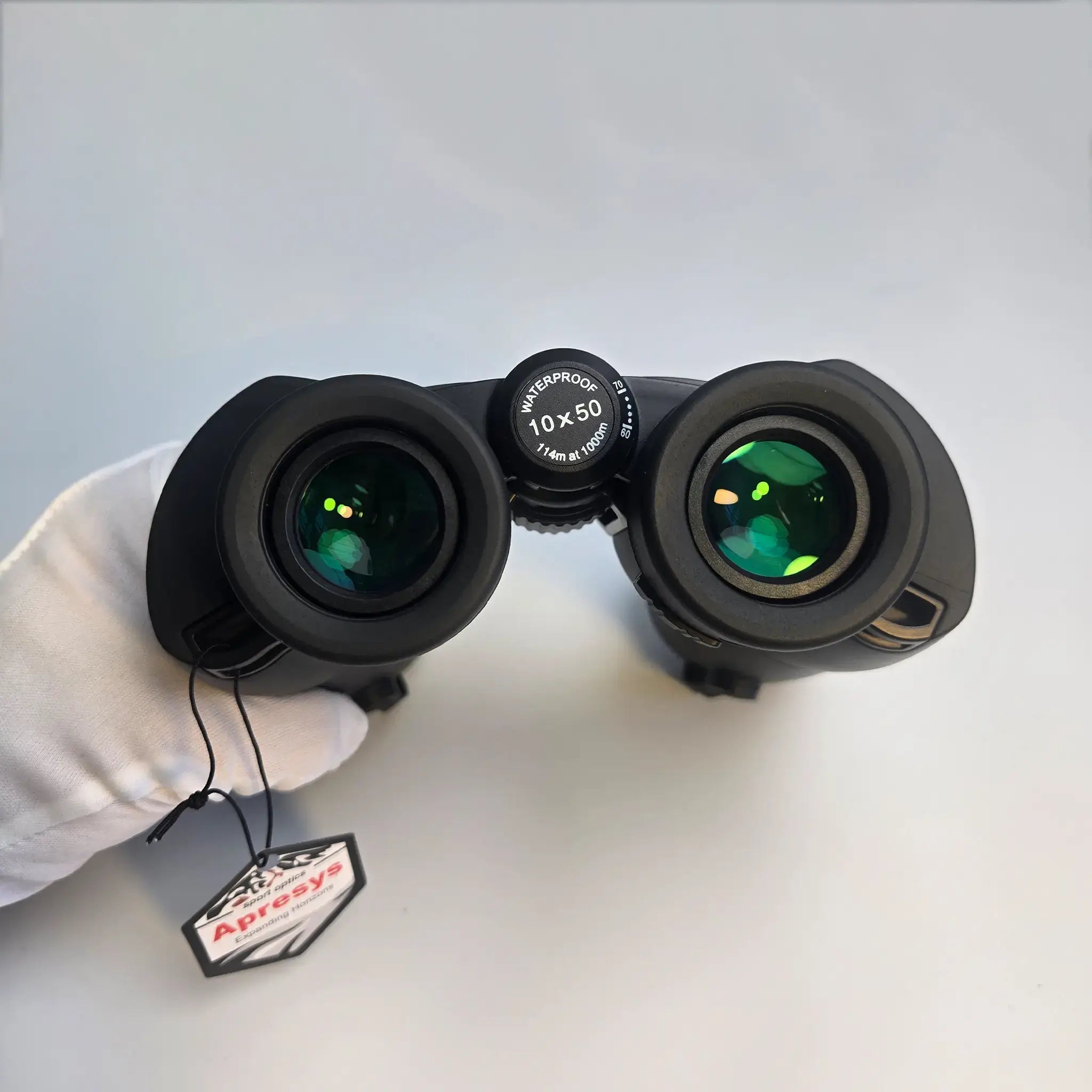 close-up of APRESYS M5010 10x50 ED binoculars eyepieces showing reflective fully multi-coated optical glass for bright and comfortable viewing