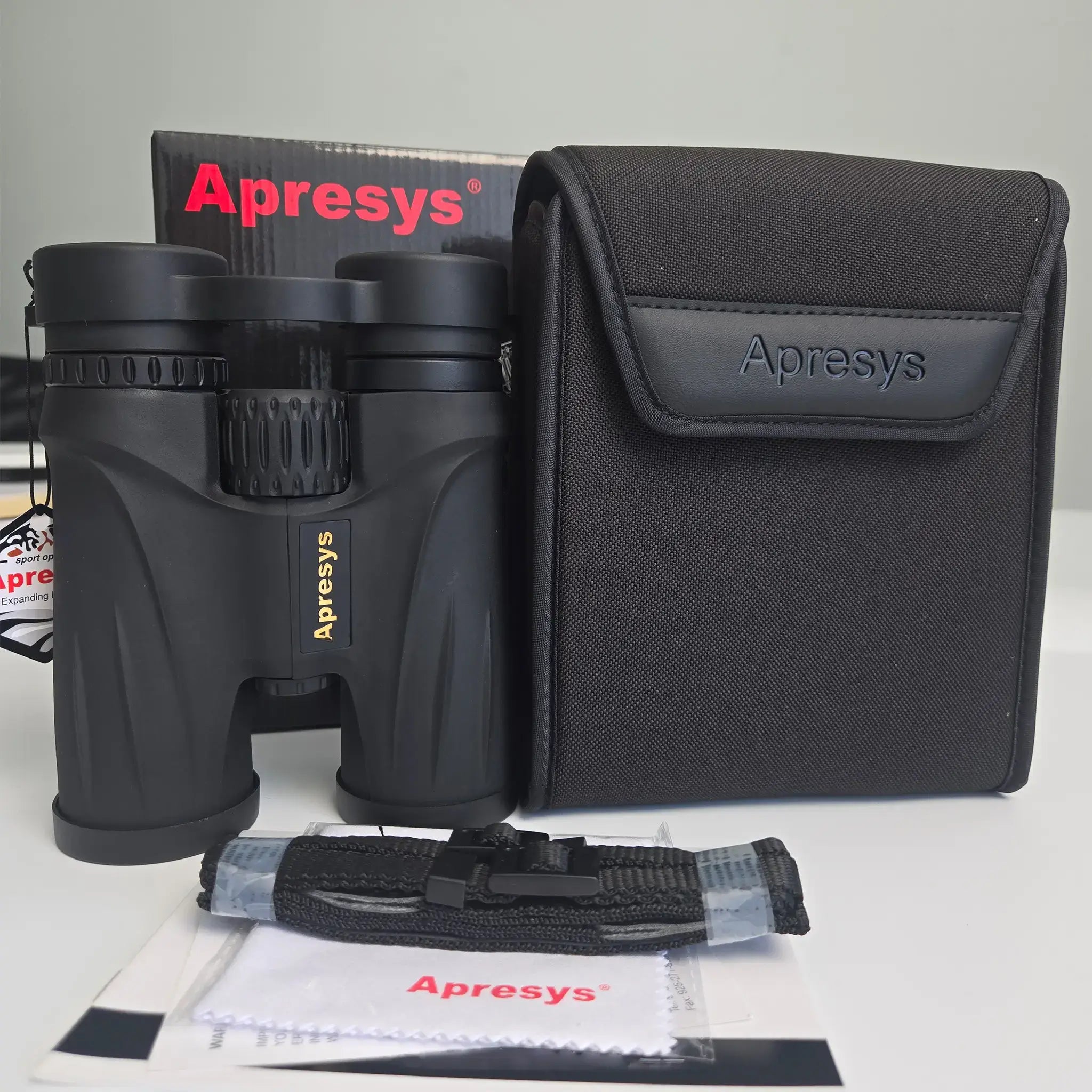APRESYS S4210 10x42 binoculars with carrying case, neck strap, lens cloth, packaging box and user manual on white background